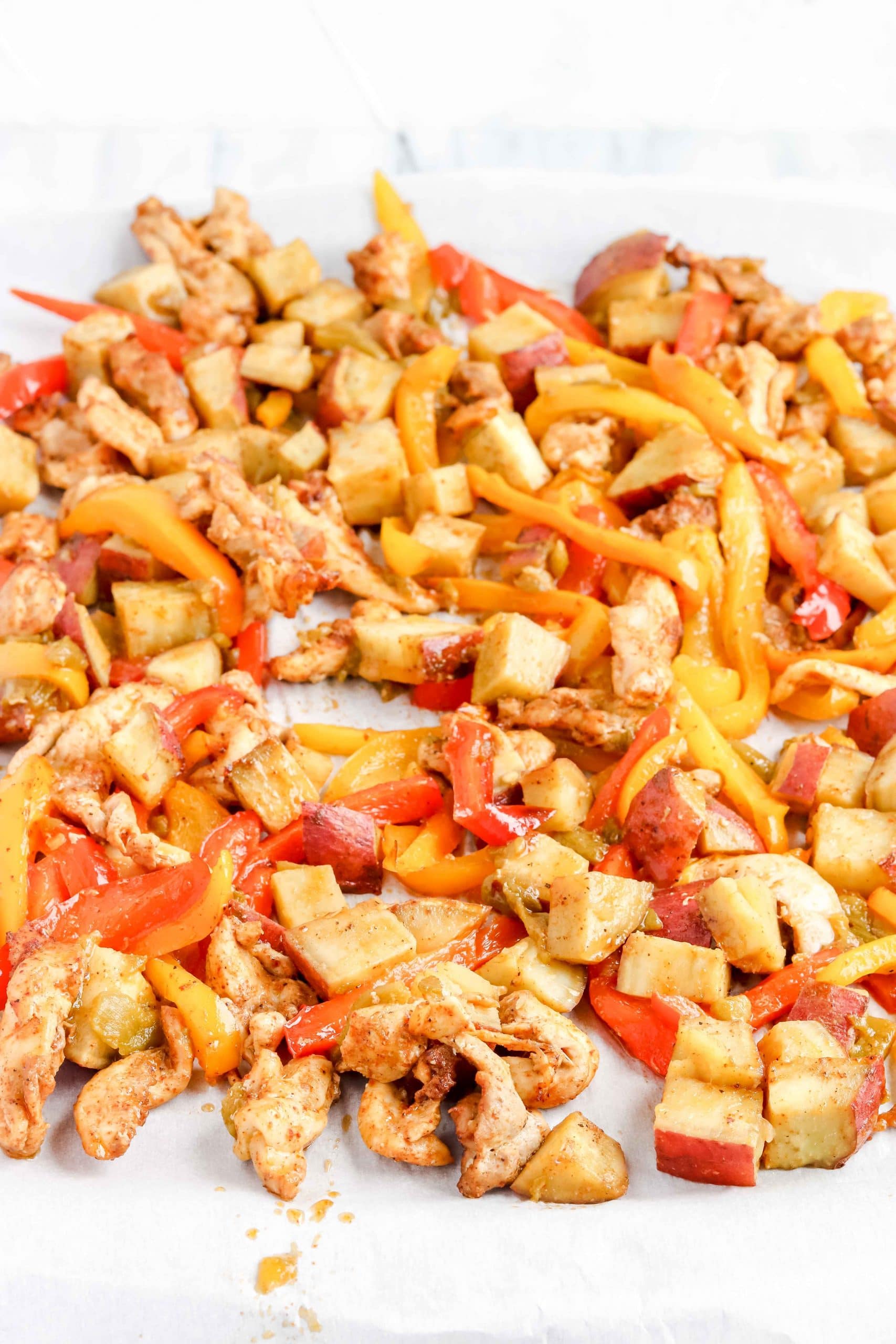 Fajita Sheet Pan with Chicken, Peppers and Sweet Potatoes. https://www.atwistedplate.com/fajita-sweet-potato-sheet-pan-dinner/